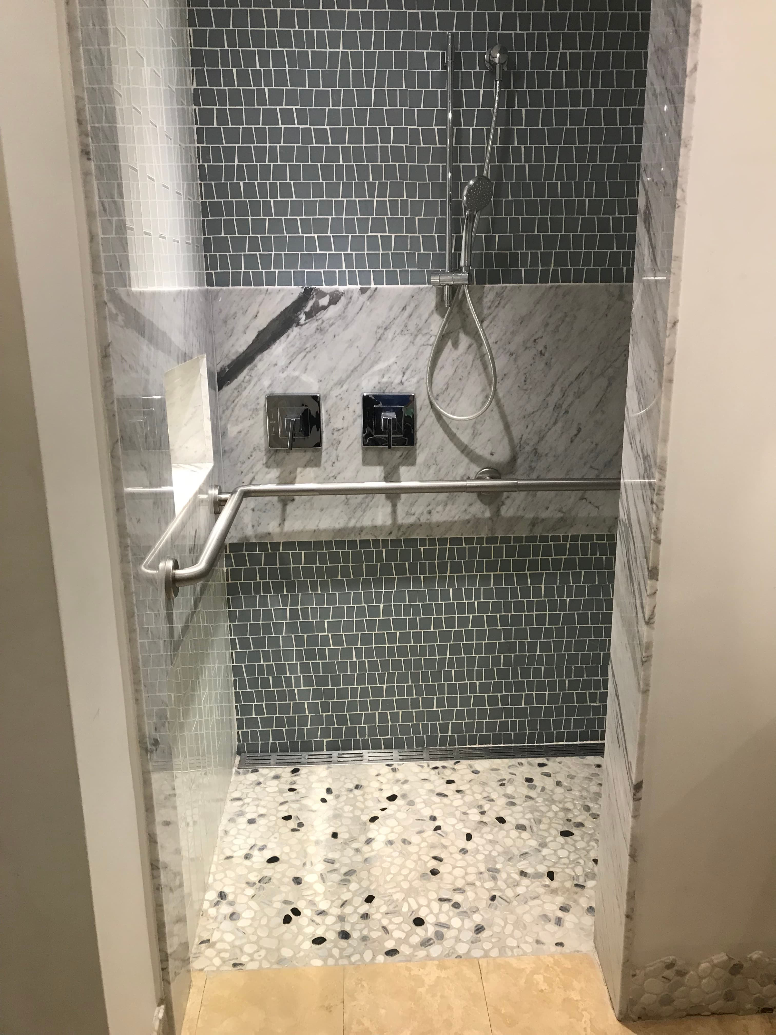 Roll in shower with grab bars and handheld shower head