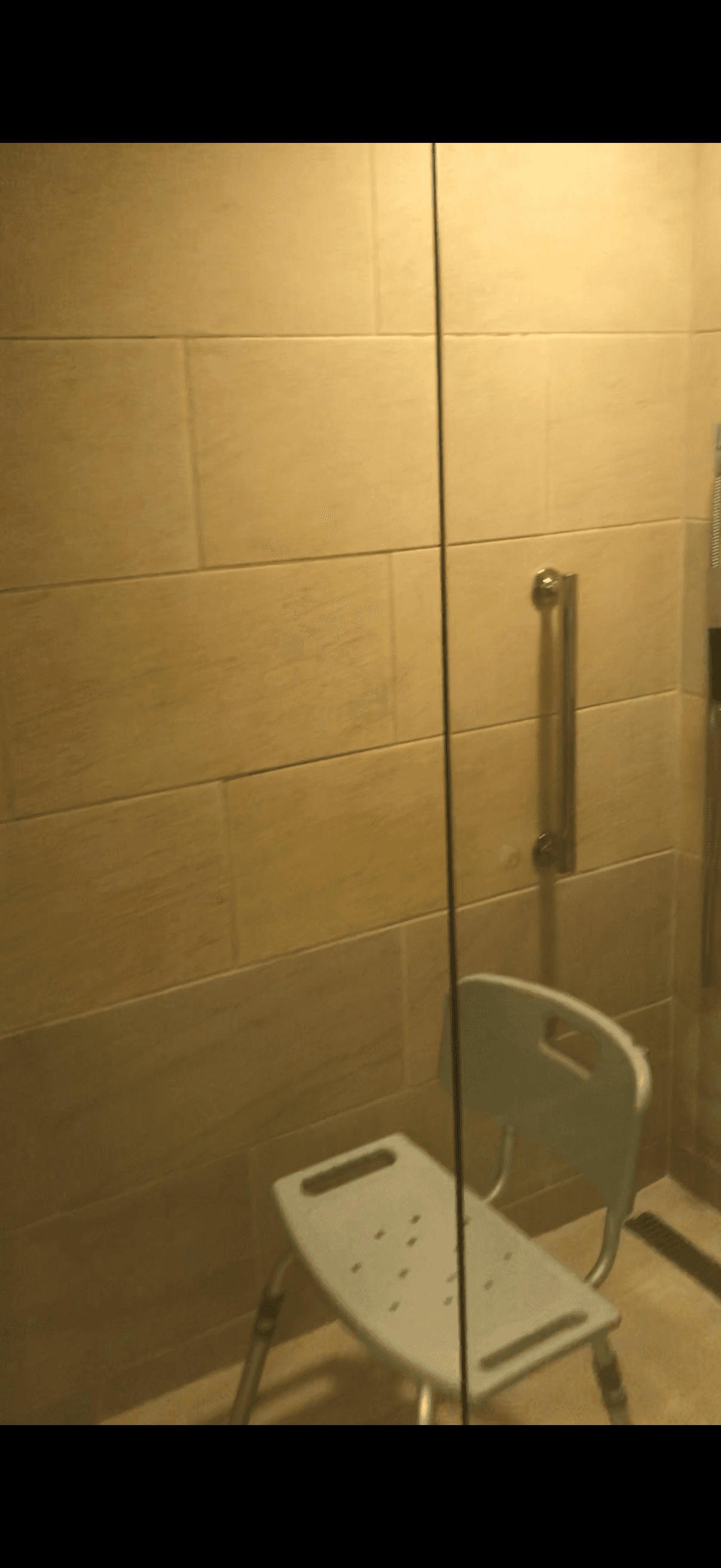Roll in shower with provided chair, just big enough
